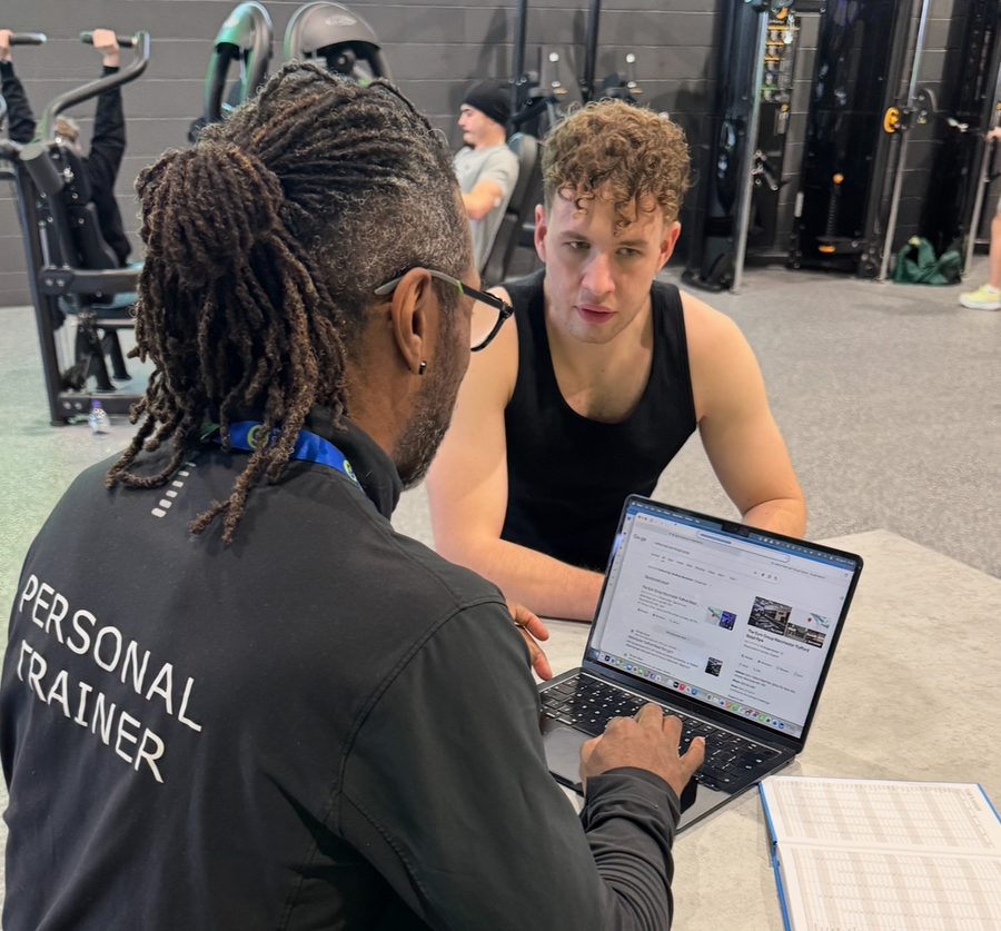 Paul going through a client's plan and progress on a laptop